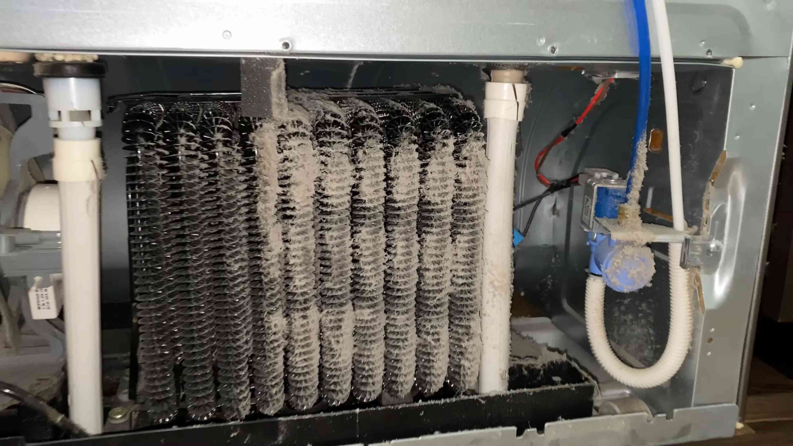 Clean refrigerator coils vacuum